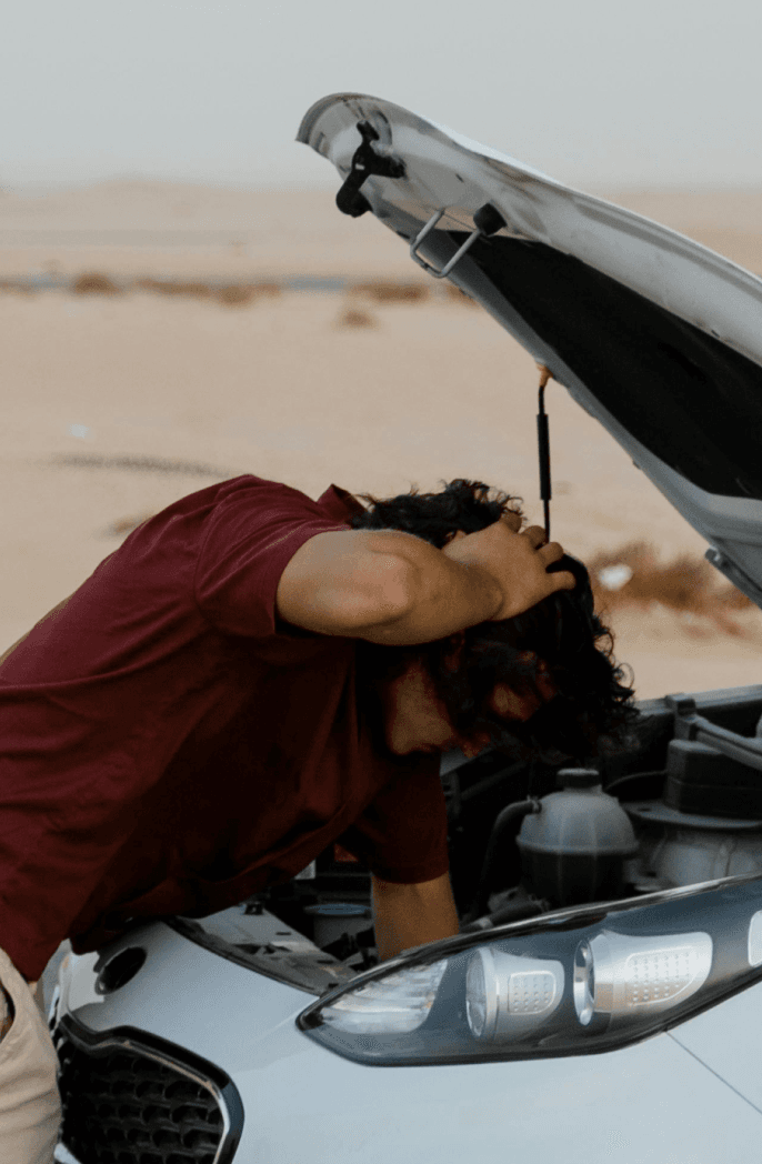 man fixing car