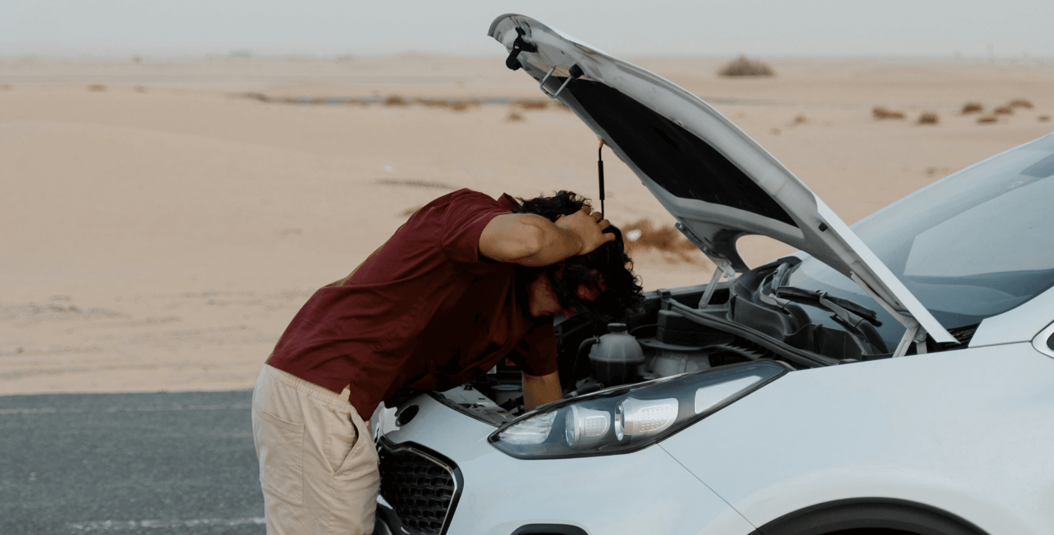 man fixing car